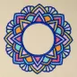 Preview: Stickdatei Set Mandalas + Split Mandala (div. Größen), Foto zeigt Ausfertigung des Ornaments auf hellem Stoff. Buntes Mandala-Ornament aus Bogen und Zacken mit kreisrundem, freiem Zentrum.