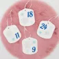 Preview: Stickdatei Set ITH Adventskalenderanhänger mit Zahlen 1-24 Anhänger in weiß mit silberner und türkiser Schneeflocke und dunkelblaue Zahl