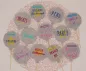 Preview: Stickdatei Set Ballon-Stabdeko ITH, Foto zeigt 12 Luftballon-Designstäbe aus mittelgrauem Filz, teilweise zusätzlich mit umrandeter Einstecköffnung. Bunte Bestickungen mit Ornamenten (Sterne, Schnörkel) und Schriftzügen ("Danke", "Nichts", "Peng", "Einlad