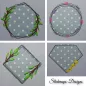 Preview: Stickdatei Set Floral Frames Doodle Applikationen, 4 Fotos mit je 1 unterschiedlichen Ausfertigung, Applikation je grauer Stoff, weißgepunktet, auf grauem Untergrund. Unterschiedliche Abstickungen: Runder Kranz mit 2 Blattranken; runder Kranz mit Pfeiltri