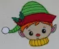 Preview: Stickdatei Set Christmas Faces Doodle-Applikationen. Foto von Applikation Jungenkopf mit Mütze, aufgebracht auf hellen Stoff.