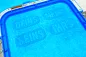 Preview: Freebie Stickdatei Set Handtuchmotive, Foto mit in Stickrahmen eingespanntem mittelblauem Frotteestoff. Vier Schriftzüge: "DEINS"/"MEINS"/"SEINS"/"IHRS", wobei die Buchstaben durch Auslassung der Bestickung entstehen, welche die Form einer länglichen Umra