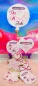 Preview: Stickdatei Set Liebe & Hochzeit - Stabdesigns, Foto mit 8 Designs, auf einer Holzscheibe präsentiert, Untergrund oranges Fell, bunter Hintergrund. Mit Einstecköse: 2 mal Luftballons ("Mr. & Mrs."; "Du & Ich"); 1 mal Herz mit Herzstick; 1 mal Schnörkelrahm