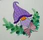 Preview: Christmas Gnome mit lila Mütze und Flechtzöpfen. Drumherum ist ein Zweig mit Schleife zu sehen.