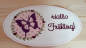Preview: Stickdatei Set Hallo Frühling (div. Rahmengrößen), Foto zeigt ovalen hellen Mug Rug. Linksseitig lila Schmetterling auf rosa-pink gemustertem Stoff, umgeben von Kranz aus Herzen und Blättern. Rechts Schriftzug "Hallo Frühling!".
