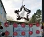 Preview: Stickdatei Set Monogramme Barock geeignet für Frottierwaren. Foto zeigt unter einem hängenden Weihnachtsdekostern zwei Reihen mit je 5 aufgereihten Buchstaben in rot-weiß, die "MERRY CHRISTMAS" ergeben.