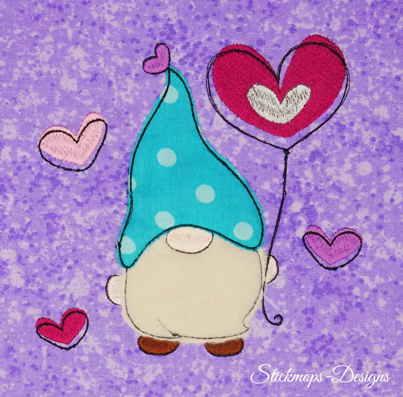 Stickdatei Set 5in1 Lovegnome Doodle-Applikationen, Foto mit Applikation auf lila-hell gemustertem Stoff. Gnom mit gepunkteter Mütze und Herzluftballon, umgeben von Herzchen.
