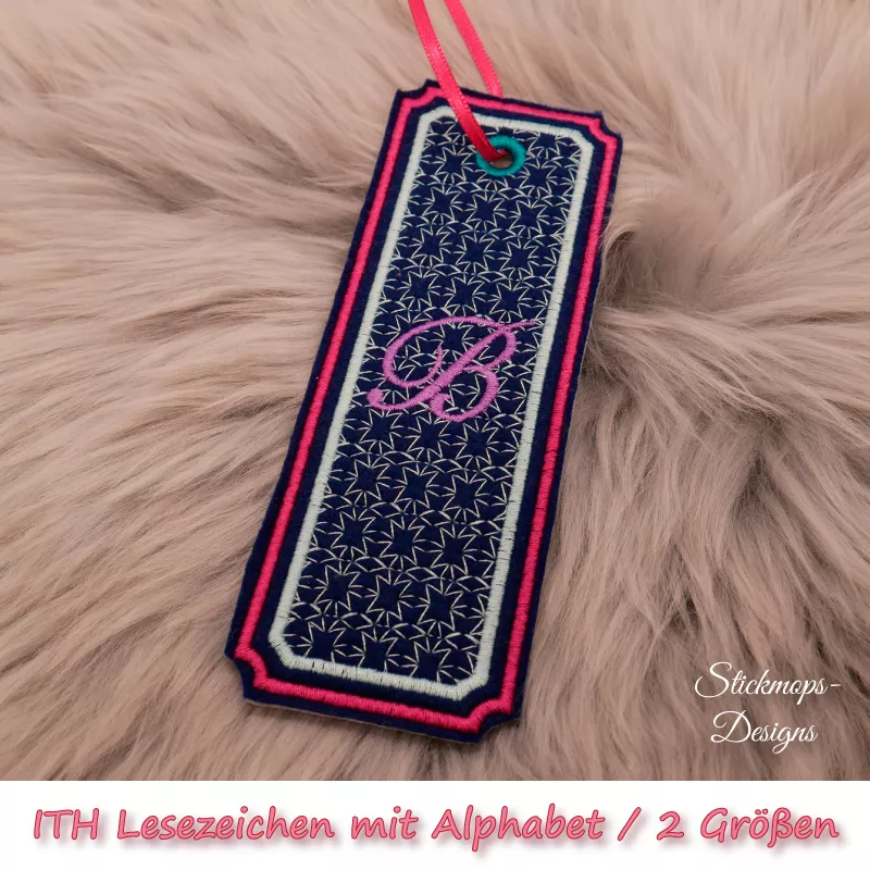 (Osterkalender-Türchen 6A) Stickdatei Set ITH Lesezeichen mit Alphabet in 2 Größen, Foto zeigt am Bändchen garngeöstes längliches Lesezeichen, rechteckig, mit eingekerbten Ecken. Schwarz, Bestickung beige-rot, filigranes Muster, in pink schnörkeliger Buch