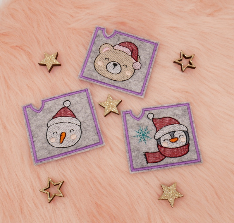 Preview: Niedliche Mini Schokohüllen mit Schneemann, Bärchen und Pinguin aus dem Stickdatei Set Christmascover.