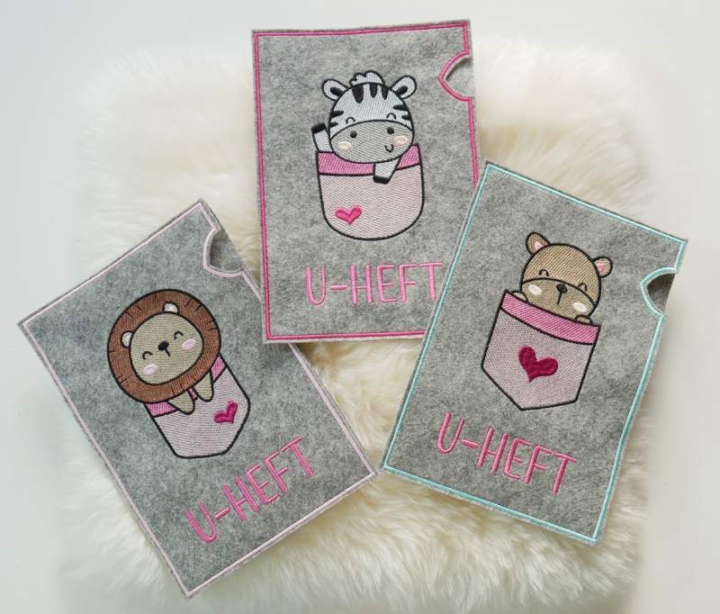 Preview: U-Heft-Hüllen mit Zebra, Löwe und Bärchen in rosa.