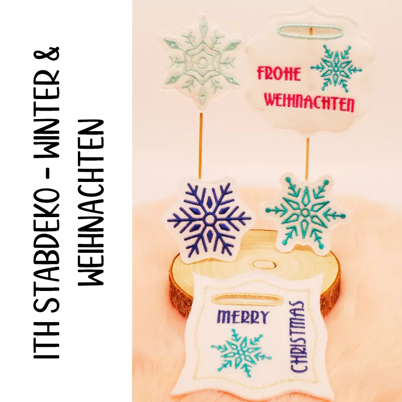 Stickdatei Set Weihnachts-Stabdesigns, Foto mit 5 Designs vor buntem Hintergrund auf Holzscheibe mit orangem Fell darunter. 3 mal unterschiedliche Eiskristalle (blau, grün bzw. türkis). 2 mal mit Einstecköffnung, Eiskristallbestickung, rahmenartiges, bzw.
