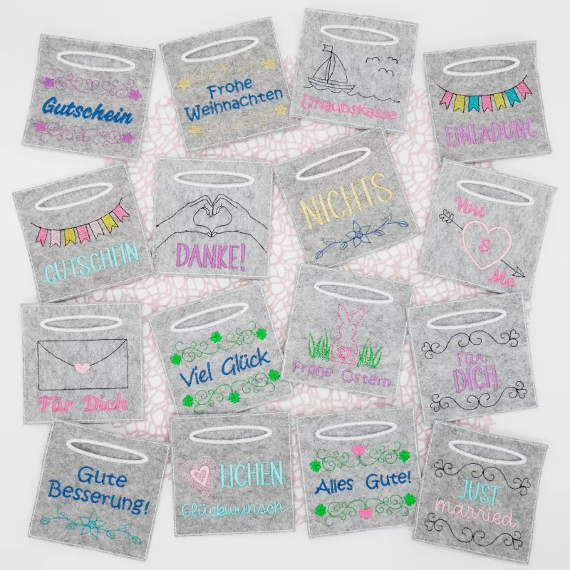 Bunt bestickte Wunscherfüller. Das sind kleine Filztaschen, in denen man Geldgeschenke verpacken kann.