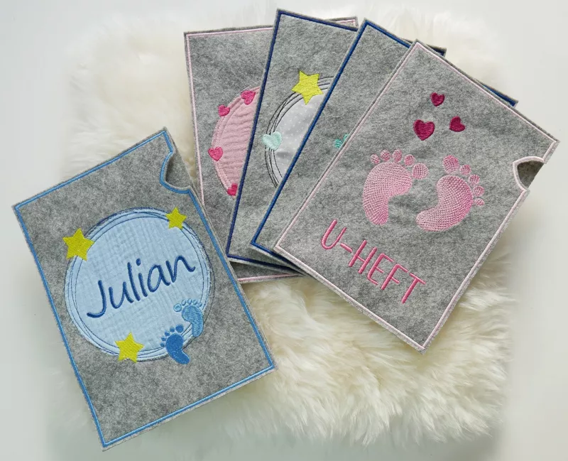 Stickdatei Set U-Hefthüllen auf weißem Fell.