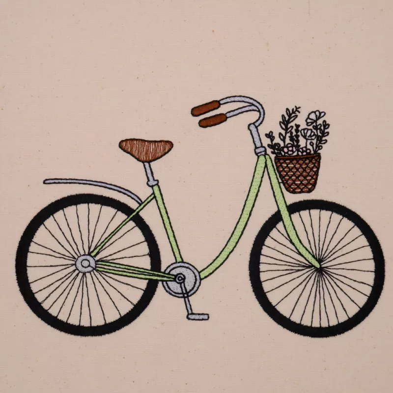 Stickdatei Damenfahrrad in grün gestickt mit Blumen im Fahrradkörbchen.