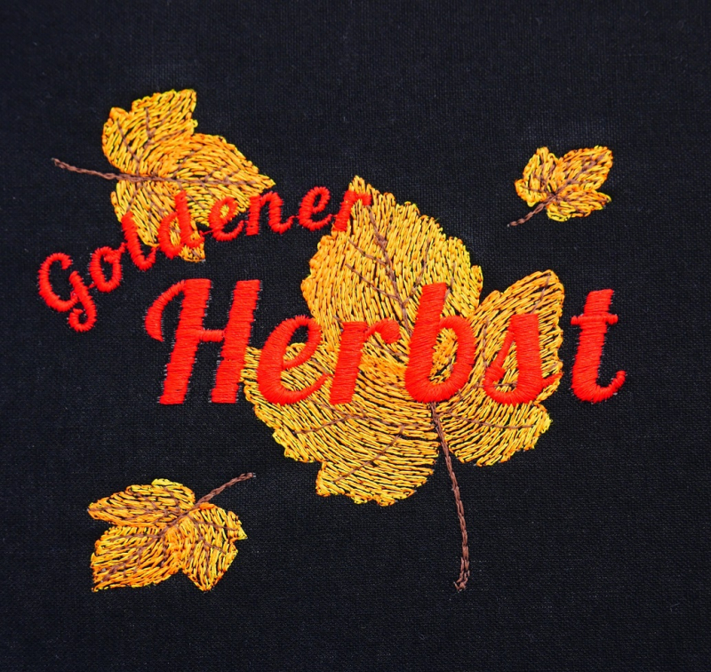 Herbstblätter in gelb und orange Tönen mit rotem Schriftzug Goldener Herbst