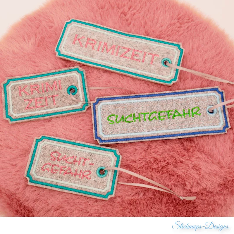 (Osterkalender-Türchen 6B) Stickdatei Set ITH Lesezeichen mit verschiedenen Füllmustern in 2 Größen. Foto zeigt 2 kurze und 2 lange hell-graubraune Ausfertigungen mit eingekerbten Ecken, garngeöst und bändchendurchzogen. Diverse Garnfarben, Schriftzüge: "