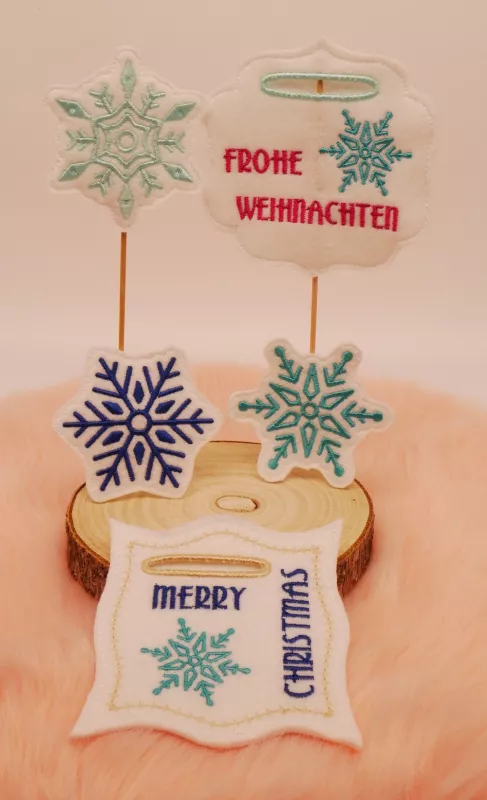 Schneeflocken Stickdateien als Stabdeko mit Schrifzug Frohe Weihnachten für Geldgeschenke.