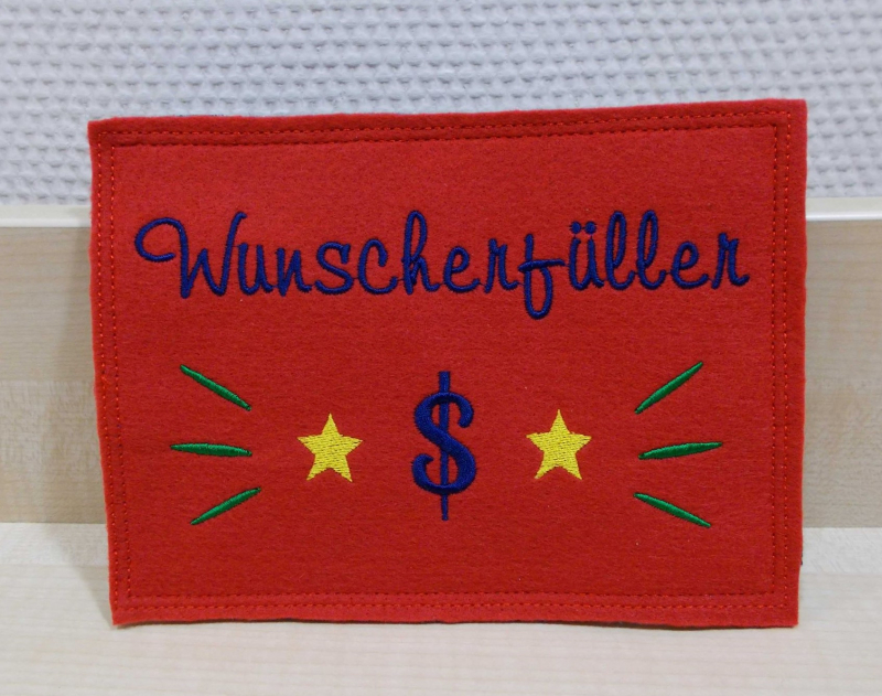 Stickdatei Set ITH Glückwunschkarten inkl. Abwandlung zur Geschenktasche (div. Rahmengr.), Foto mit Querformat-Ausfertigung in rot. Kontrastige Bestickung mit Sternen, Dollarzeichen, Strahlen und Schriftzug "Wunscherfüller".