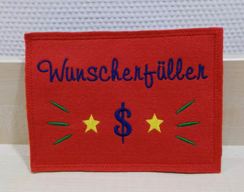Stickdatei Set ITH Glückwunschkarten inkl. Abwandlung zur Geschenktasche (div. Rahmengr.), Foto mit Querformat-Ausfertigung in rot. Kontrastige Bestickung mit Sternen, Dollarzeichen, Strahlen und Schriftzug "Wunscherfüller".